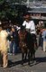 China: Naxi horseman in Old Market Square (Sifang Jie), Lijiang Old Town, Yunnan Province